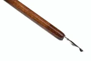 black ink drop on tip of nib of brown dip pen