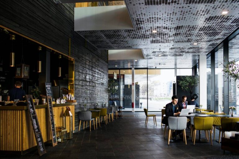 Businessmen sitting at tables in restaurant
