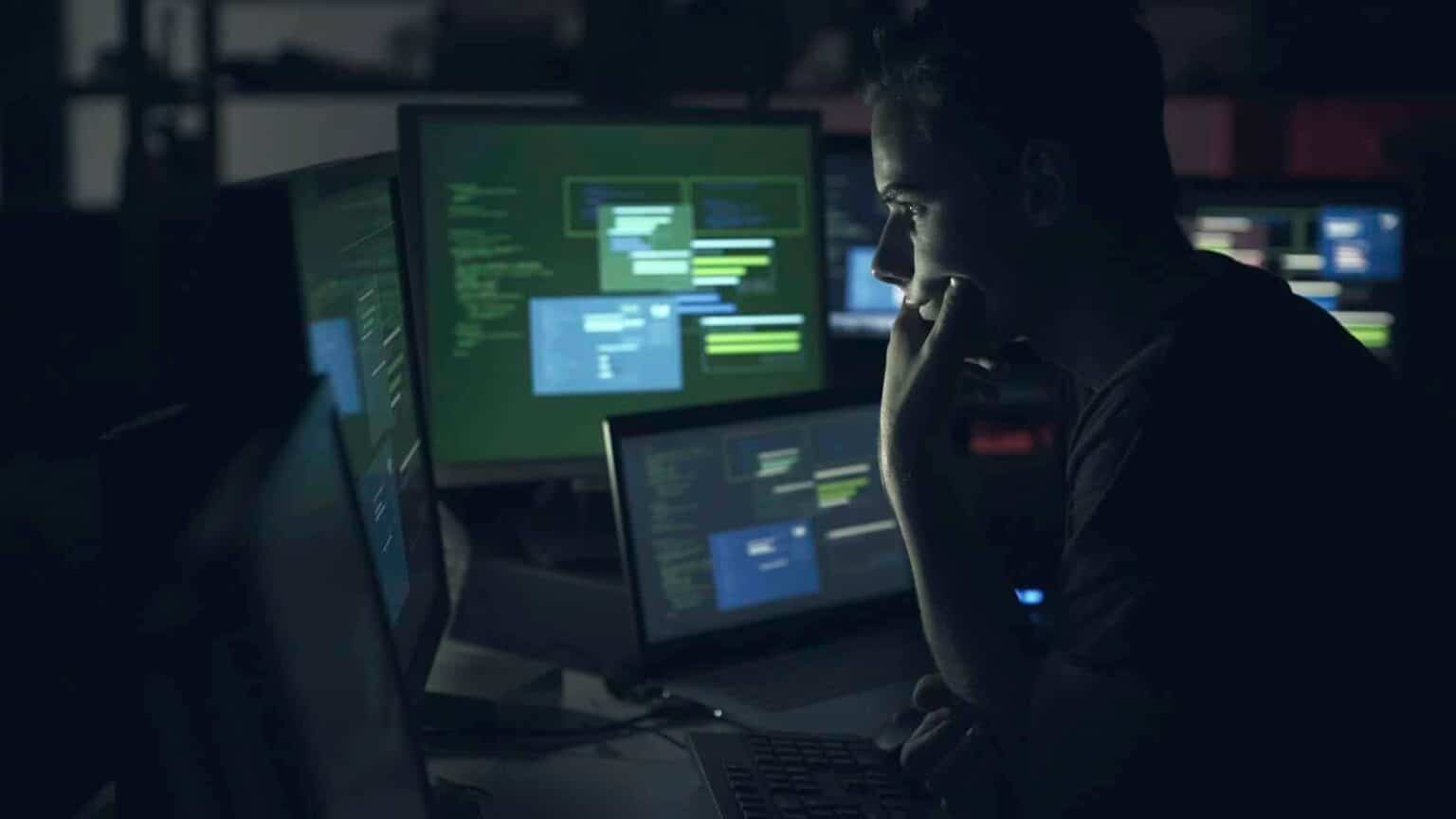 Computer developer working with computers at night
