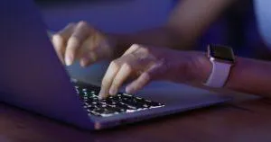 Woman work on laptop computer at night